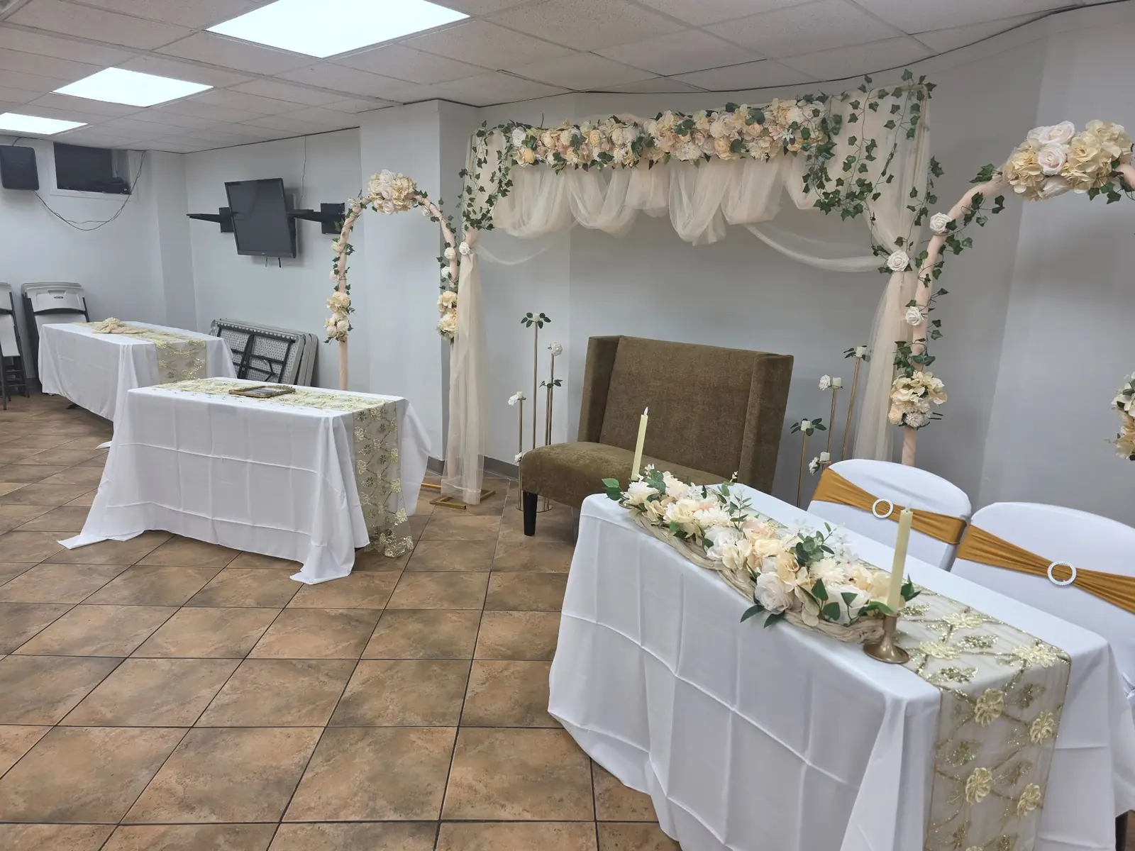 Tables and decorated arches set up in the community hall